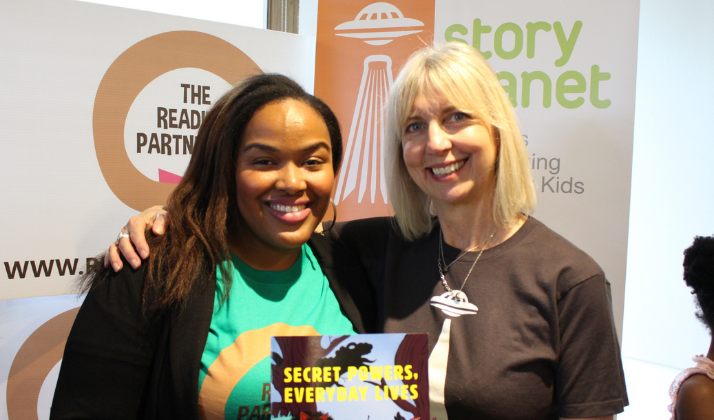 Camesha Cox of The Reading Partnership and Liz Haines of Story Planet holding a book together